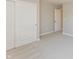 Bedroom with closet with sliding doors, plush neutral carpeting, and a door to another room at 1101 Knoll Ct, Greenwood, IN 46143
