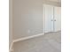 This is a bedroom that features neutral colored walls, white doors, and carpet at 1101 Knoll Ct, Greenwood, IN 46143
