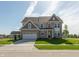 Two-story brick home featuring an attached two-car garage and a well-manicured front yard at 1101 Knoll Ct, Greenwood, IN 46143
