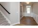 Foyer with stairs, light walls, hardwood floors, and a front door with glass panes at 1101 Knoll Ct, Greenwood, IN 46143
