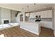 Open concept kitchen with white cabinets, quartz countertops, stainless appliances and fireplace at 1101 Knoll Ct, Greenwood, IN 46143