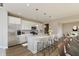 Bright kitchen boasts stainless appliances, a large island with seating, and stylish pendant lighting at 1101 Knoll Ct, Greenwood, IN 46143