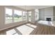 Bright living area with hardwood floors, large windows, and a fireplace at 1101 Knoll Ct, Greenwood, IN 46143