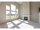 Light-filled living room with large windows, neutral gray walls, fireplace, and plush carpeting at 1101 Knoll Ct, Greenwood, IN 46143