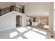 Open-concept living area with staircase, flows into a kitchen with white cabinets at 1101 Knoll Ct, Greenwood, IN 46143