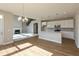 Open-concept kitchen and living area with hardwood floors, fireplace and pendant lighting at 1101 Knoll Ct, Greenwood, IN 46143