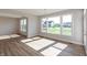 Bright living area featuring hardwood floors and large windows that let in natural light at 1101 Knoll Ct, Greenwood, IN 46143