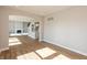 Open-concept living room flows into kitchen, with hardwood floors, neutral walls, and ample natural light at 1101 Knoll Ct, Greenwood, IN 46143