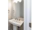 Pedestal sink with modern faucet, large mirror, and stylish fixtures at 1101 Knoll Ct, Greenwood, IN 46143