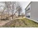 Backyard view featuring sparse grass, some bare trees and the side of the house at 11410 Dunshire Dr, Indianapolis, IN 46229