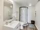 Bright bathroom featuring a stand up shower with black trim and white tile at 11410 Dunshire Dr, Indianapolis, IN 46229