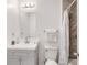 Bathroom featuring a white vanity, toilet, and a tiled shower with a decorative curtain at 11410 Dunshire Dr, Indianapolis, IN 46229