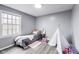 bedroom with grey walls and a bright window view at 11410 Dunshire Dr, Indianapolis, IN 46229