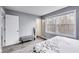 Bright bedroom with grey walls, two windows, and a decorative bench at 11410 Dunshire Dr, Indianapolis, IN 46229