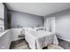 Cozy bedroom with soft white bedding, decorative accents, and soothing gray walls create a relaxing atmosphere at 11410 Dunshire Dr, Indianapolis, IN 46229