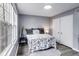 Cozy bedroom featuring grey walls, wood floors, and a large window for natural light at 11410 Dunshire Dr, Indianapolis, IN 46229