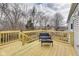 Outdoor deck with wood railings and a table and chair overlooking a treed backyard at 11410 Dunshire Dr, Indianapolis, IN 46229