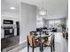 Open-concept dining area with modern table setting and natural light, adjacent to living room and kitchen at 11410 Dunshire Dr, Indianapolis, IN 46229