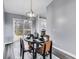 Stylish dining area with a round table set for four, with access to the kitchen and outdoor deck at 11410 Dunshire Dr, Indianapolis, IN 46229