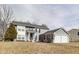 Charming two-story home with gray siding, a well-manicured lawn, and an attached two-car garage at 11410 Dunshire Dr, Indianapolis, IN 46229