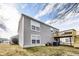 Two-story home featuring gray siding, white-trimmed windows, and a wooden deck under a cloudy sky at 11410 Dunshire Dr, Indianapolis, IN 46229