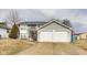 Classic two-story home with gray siding and an attached two-car garage in a suburban setting at 11410 Dunshire Dr, Indianapolis, IN 46229