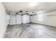 Spacious two car garage with concrete floors and a white painted interior, offering ample storage and parking space at 11410 Dunshire Dr, Indianapolis, IN 46229