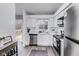 Contemporary kitchen with white cabinets, stainless steel appliances, and a view to the backyard at 11410 Dunshire Dr, Indianapolis, IN 46229