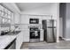 Modern kitchen with white cabinets, stainless steel appliances, and sleek countertops at 11410 Dunshire Dr, Indianapolis, IN 46229