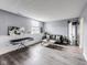 A brightly lit living room featuring stylish gray walls, hardwood floors, and comfortable seating at 11410 Dunshire Dr, Indianapolis, IN 46229