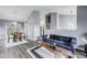 Open-concept living room and dining area with modern furnishings and sleek gray flooring at 11410 Dunshire Dr, Indianapolis, IN 46229