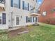 A backyard view with a small patio, a well-maintained lawn, and classic siding at 11936 Esty Way, Carmel, IN 46033