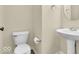 Cozy half bathroom features a pedestal sink and well-maintained fixtures at 11936 Esty Way, Carmel, IN 46033