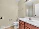 Neutral bathroom featuring a single sink vanity, toilet and shower-tub combo with glass doors at 11936 Esty Way, Carmel, IN 46033