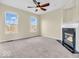 Bedroom with large windows, ceiling fan, neutral walls, and fireplace at 11936 Esty Way, Carmel, IN 46033