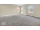 Bright bedroom featuring neutral carpet, three windows providing lots of natural light and fresh paint at 11936 Esty Way, Carmel, IN 46033