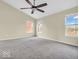 Bright and airy bedroom featuring plush carpeting and ample natural light from the windows at 11936 Esty Way, Carmel, IN 46033