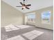 Spacious bedroom with carpet, ceiling fan, and natural light from two large windows at 11936 Esty Way, Carmel, IN 46033