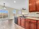 Bright kitchen with sliding glass doors, wooden cabinets, and black appliances at 11936 Esty Way, Carmel, IN 46033
