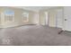 Spacious living room with neutral carpet, lots of light, and a doorway to the back yard at 11936 Esty Way, Carmel, IN 46033