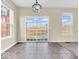 Open living room with sliding glass doors to patio, large windows, and chandelier at 11936 Esty Way, Carmel, IN 46033