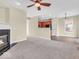 Inviting living room featuring a fireplace, ceiling fan, and seamless flow into the kitchen at 11936 Esty Way, Carmel, IN 46033
