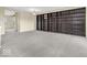 Spacious living room with gray carpet and floor-to-ceiling built-in shelving unit at 11936 Esty Way, Carmel, IN 46033