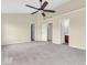 Large main bedroom featuring a ceiling fan and multiple closets for ample storage at 11936 Esty Way, Carmel, IN 46033