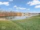 Waterfront view from a grass lawn that overlooks the pond at 11936 Esty Way, Carmel, IN 46033