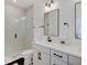 Modern bathroom featuring a glass-enclosed shower and a white vanity with black fixtures at 1208 N Alabama St, Indianapolis, IN 46202