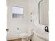Bright half-bathroom with window, toilet, and modern sink at 1208 N Alabama St, Indianapolis, IN 46202