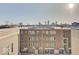 Multi-unit building featuring a mix of brick and siding, with views of the city skyline in the distance at 1208 N Alabama St, Indianapolis, IN 46202