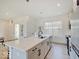 Bright kitchen features a large island with quartz countertops, stainless steel appliances, and modern pendant lighting at 1208 N Alabama St, Indianapolis, IN 46202