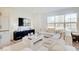 Sunlit living room features a large sectional sofa, modern decor, and a view of the outdoors at 1208 N Alabama St, Indianapolis, IN 46202